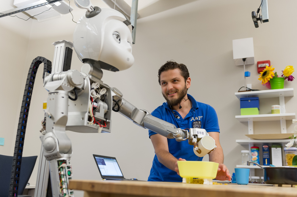 Researcher working on robot arm in lab setting