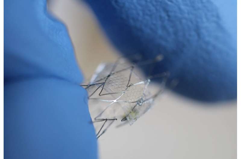 With gloved fingers for scale, a flow sensor is shown here on a stent backbone. Credit: Woon-Hong Yeo, Georgia Tech