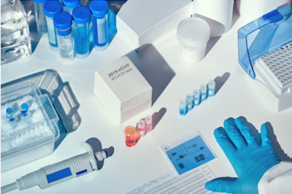 Picture of Covid tests, vials, gloved hand