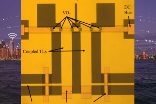 A gold circuitboard with dark rectangular markings against a cityscape background with a wireless symbol over a building.