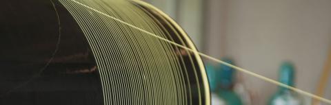 String-like advanced material on spool